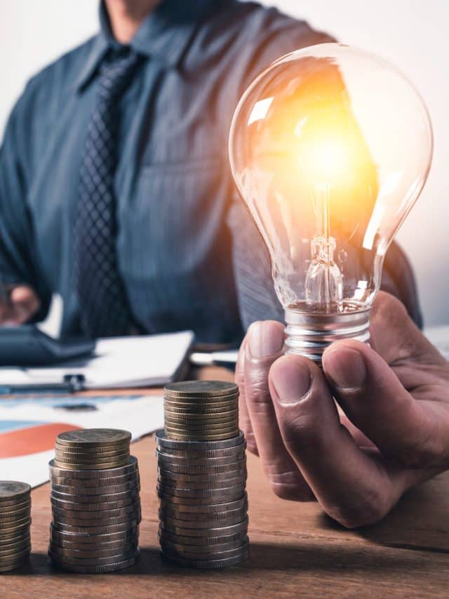 business-man-holding-light-bulb-with-coins-money-copy-space-accounting-ideas-creative-concept
