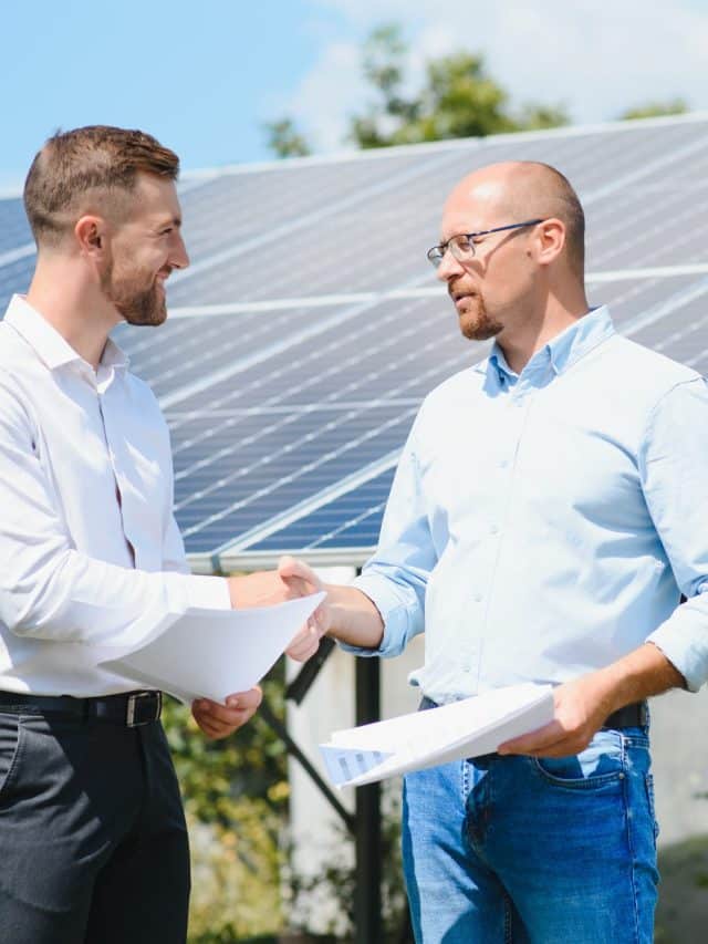 The solar farm(solar panel) with two engineers walk to check the operation of the system, Alternative energy to conserve the world's energy, Photovoltaic module idea for clean energy production