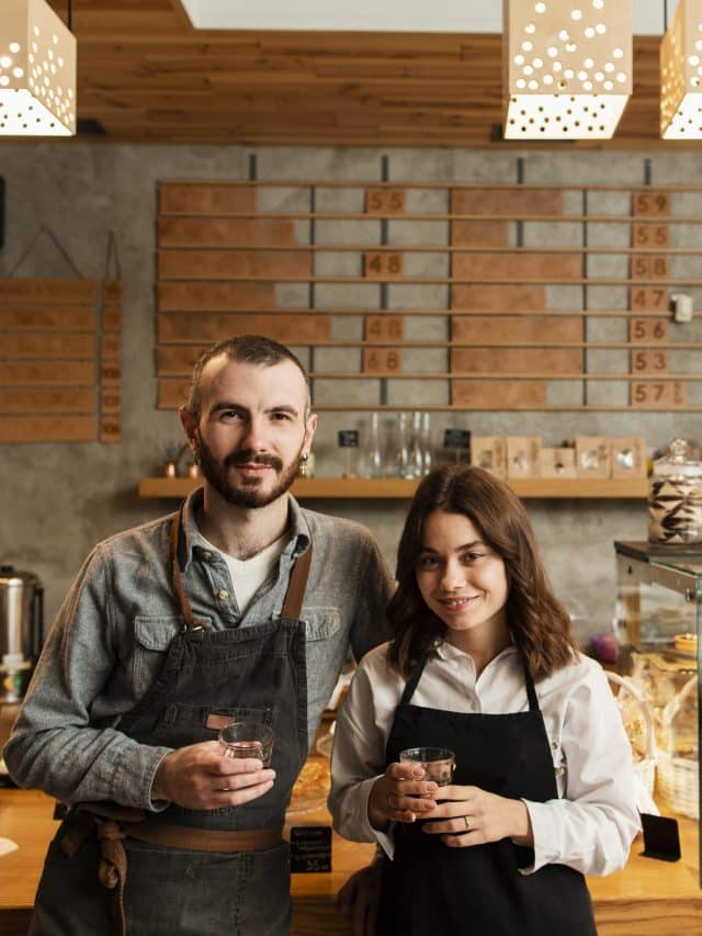 couple-aprons-posing-with-cups-coffee (1)