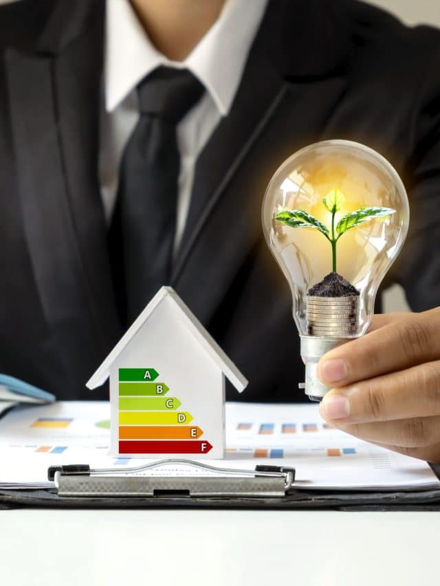 businessman-hand-holding-energy-saving-light-bulb-with-plants-growing-coins-light-bulbs