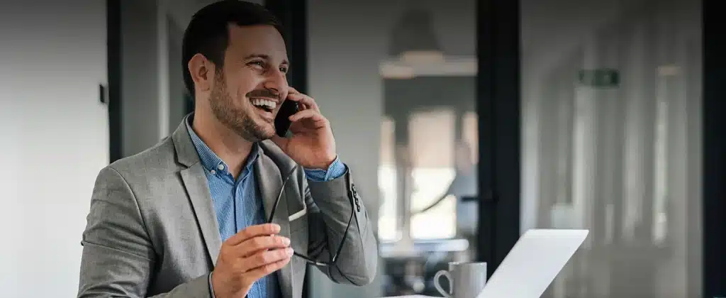 Homem ao celular sorrindo para artigo Renda Extra para Integradores em Usinas de Locação