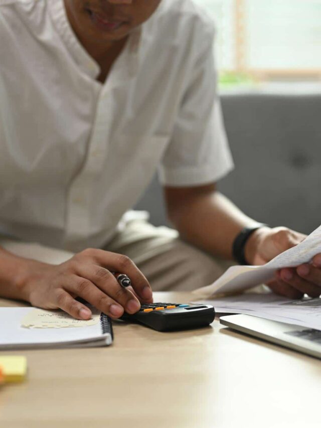 man-paying-bills-online-laptop-calculating-household-expenditures-with-calculator-household-finances (1)