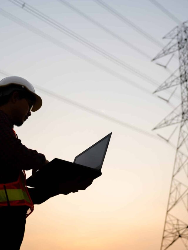 Silhouette of an electrical engineer standing at a power station to view the power generation