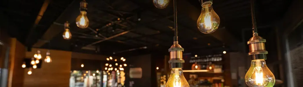 Teto com lâmpadas amarelas para iluminar restaurante para artigo sobre Como usar aparelho para economizar energia